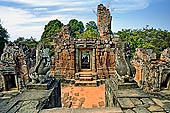 Angkor - Eastern Mebon - towered passageways leading to the first enclosure of the temple,  with stone lions guarding the entrance.